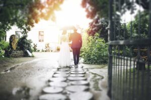 a man and woman walking down a path with an umbrella