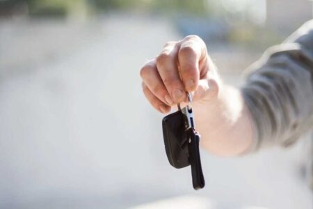 a hand holding a car key