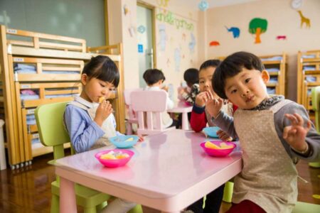 a group of children eating at a table
